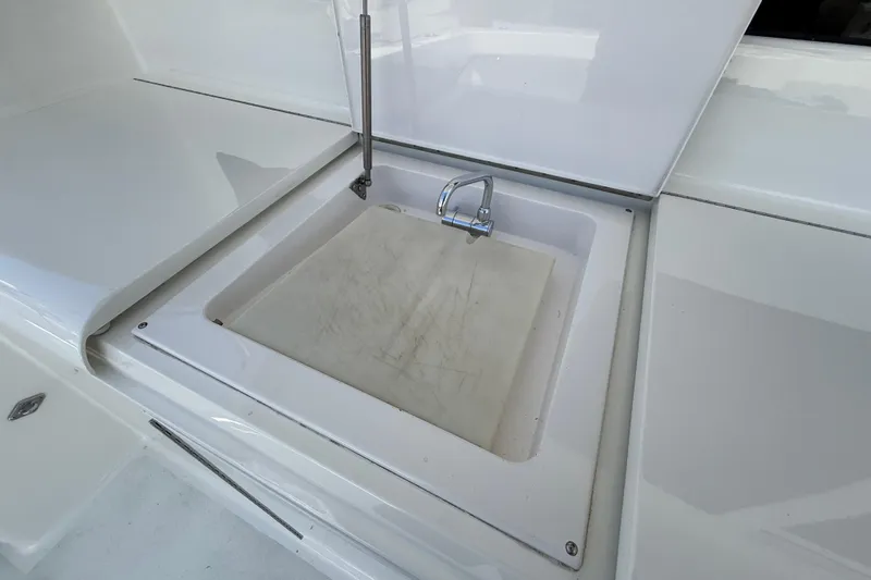 Slide: The Image of Open sink area on 2002 Viking 48 Convertible yacht with cutting board and faucet. - 69