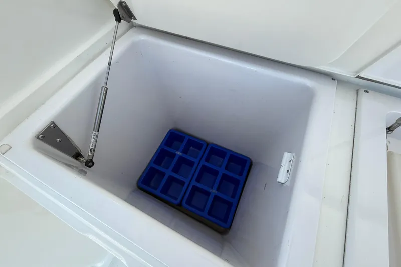 Slide: The Image of Open storage compartment with blue ice tray on 2002 Viking 48 Convertible boat. - 70