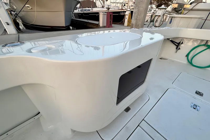 Slide: The Image of 2002 Viking 48 Convertible yacht deck with sleek white finish and storage compartment. - 72