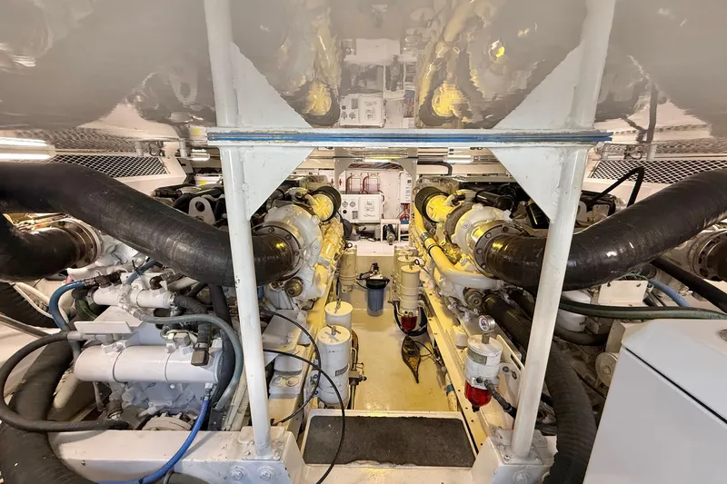 Slide: The Image of Engine room of a 2002 Viking 48 Convertible yacht, showcasing dual engines and mechanical components. - 73