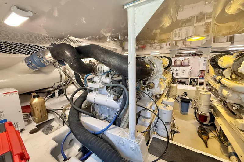 Slide: The Image of Engine room of a 2002 Viking 48 Convertible yacht, showcasing complex machinery and components. - 74