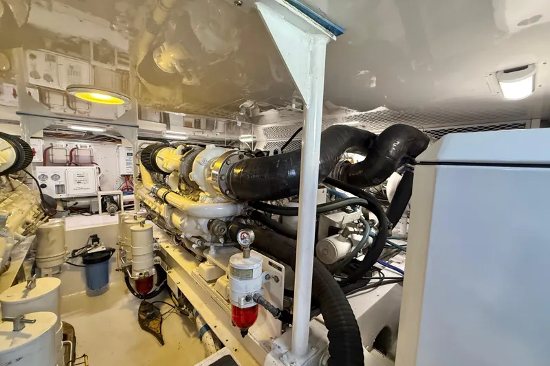 Slide: The Image of Engine room of a 2002 Viking 48 Convertible yacht, showcasing machinery and components. - 75
