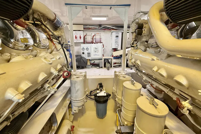 Slide: The Image of Engine room of a 2002 Viking 48 Convertible yacht, showcasing machinery and components. - 76
