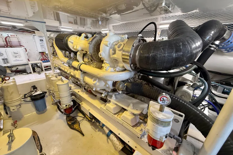 Slide: The Image of Engine room of a 2002 Viking 48 Convertible yacht, showcasing detailed machinery. - 77