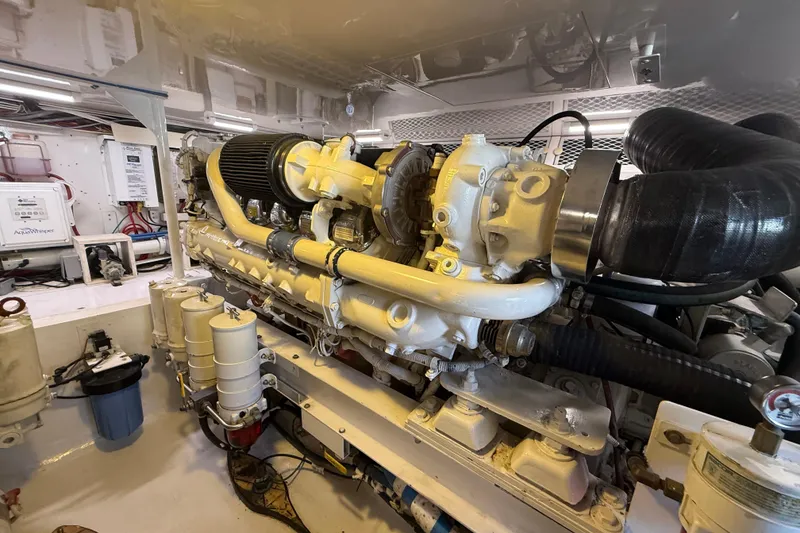 Slide: The Image of Engine room of a 2002 Viking 48 Convertible yacht, showcasing detailed machinery. - 78