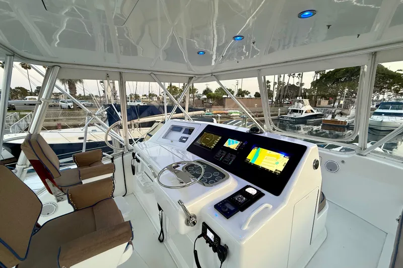 Slide: The Image of Helm of 2002 Viking 48 Convertible yacht with modern navigation equipment and comfortable seating. - 9