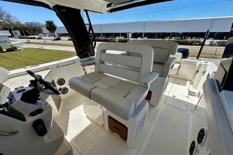 Slide: The Image of Interior view of 2023 Boston Whaler 350 Realm boat, featuring luxurious seating and modern controls. - 12