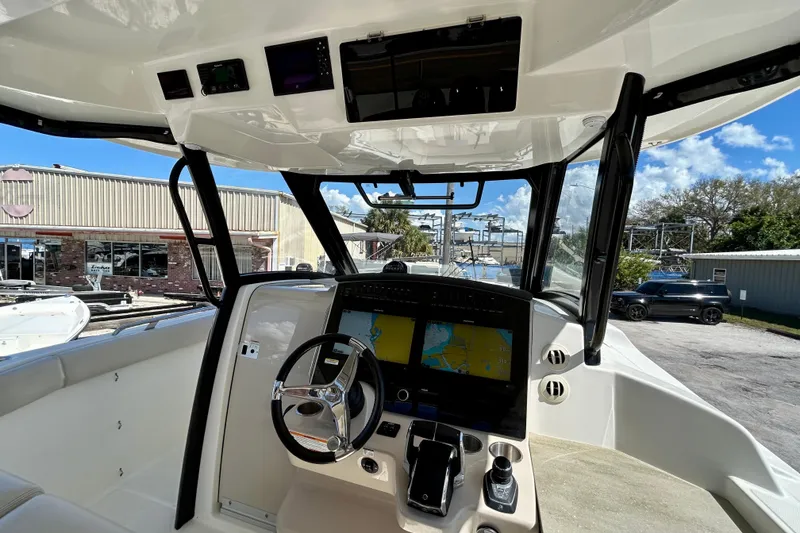 Slide: The Image of 2023 Boston Whaler 350 Realm helm with dual navigation screens and modern controls. - 13