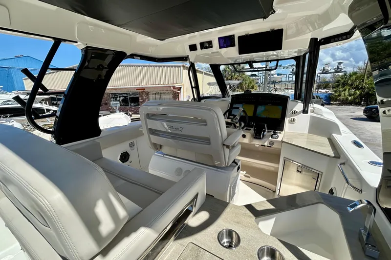 Slide: The Image of Interior view of 2023 Boston Whaler 350 Realm boat, featuring modern helm and seating. - 14