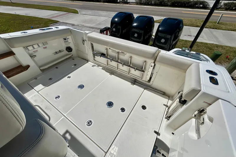 Slide: The Image of 2023 Boston Whaler 350 Realm boat deck with triple outboard engines. - 4