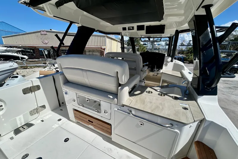 Slide: The Image of 2023 Boston Whaler 350 Realm interior with seating and helm, showcasing luxury and functionality. - 9