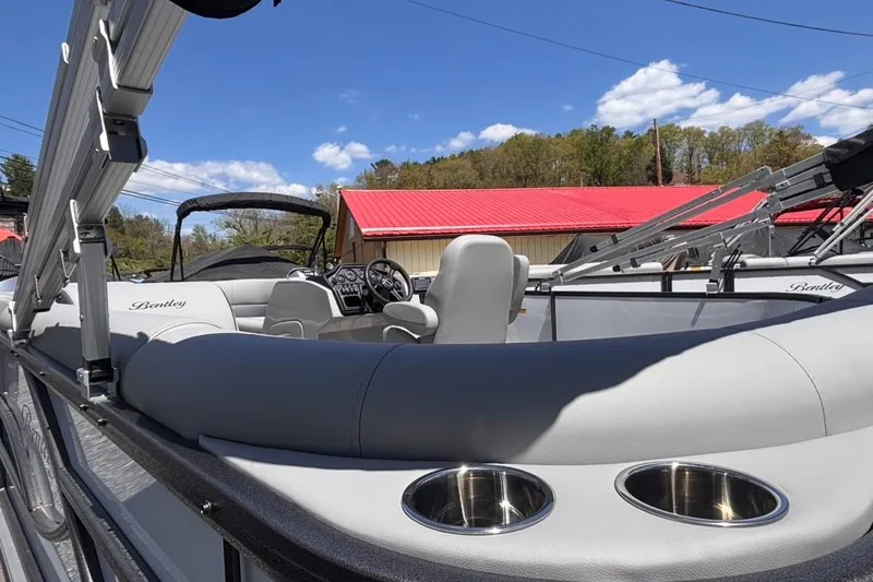 Slide: The Image of 2026 Bentley Pontoons Legacy 220 Cruise XL interior with plush seating and cup holders. - 4