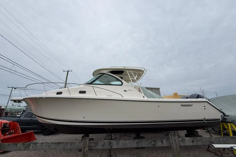 The Image of 2012 Pursuit OS 315 Offshore boat displayed on a stand, side view. - 0