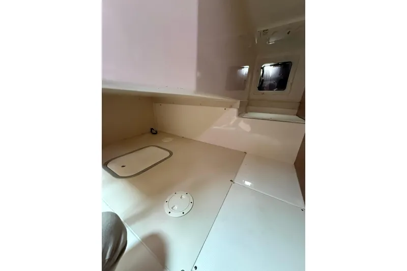 Slide: The Image of Interior cabin of 2012 Pursuit OS 315 Offshore boat, featuring sleek design and storage compartments. - 10