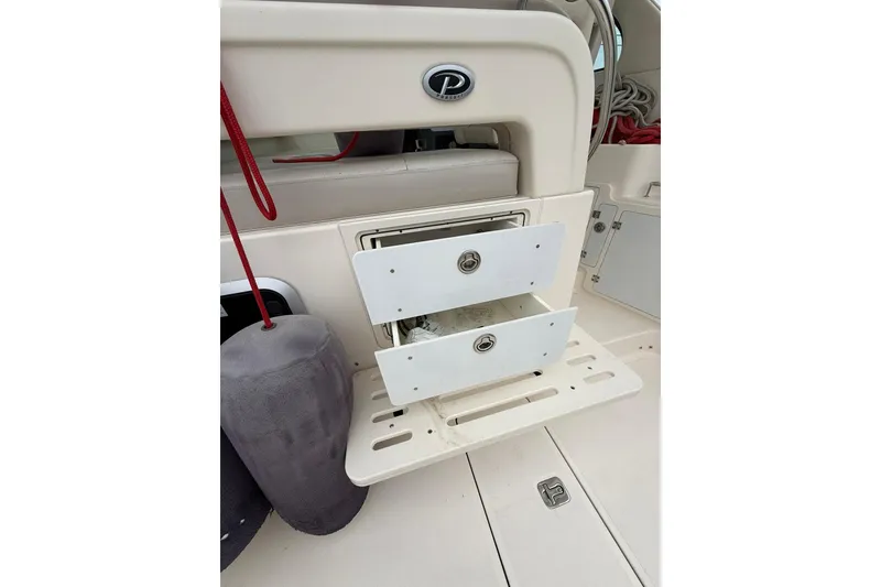 Slide: The Image of Storage drawers on a 2012 Pursuit OS 315 Offshore boat, featuring a sleek design. - 16