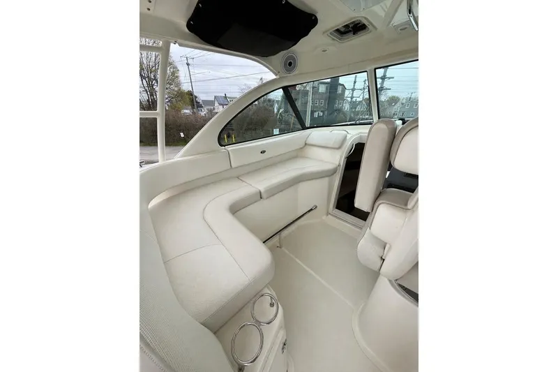 Slide: The Image of Interior of a 2012 Pursuit OS 315 Offshore boat, featuring plush seating and modern design. - 17