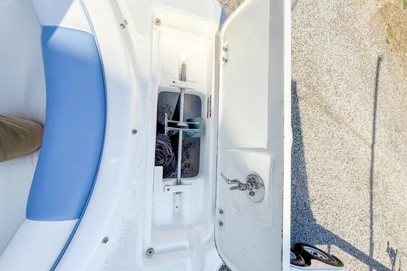 Slide: The Image of 2012 Pursuit OS 315 Offshore boat anchor compartment with blue seating detail. - 3