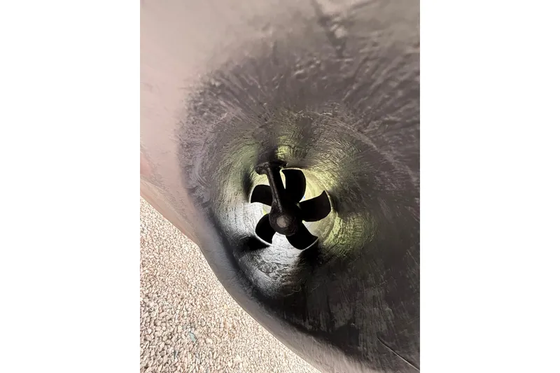 Slide: The Image of Close-up of a 2012 Pursuit OS 315 Offshore boat propeller in a tunnel hull. - 4