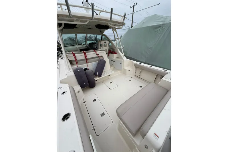 Slide: The Image of 2012 Pursuit OS 315 Offshore boat interior with seating and storage compartments. - 6