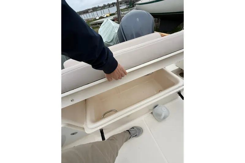 Slide: The Image of 2012 Pursuit OS 315 Offshore boat with open storage compartment on deck. - 7