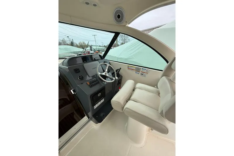 Slide: The Image of Helm of 2012 Pursuit OS 315 Offshore boat with steering wheel and controls. - 8