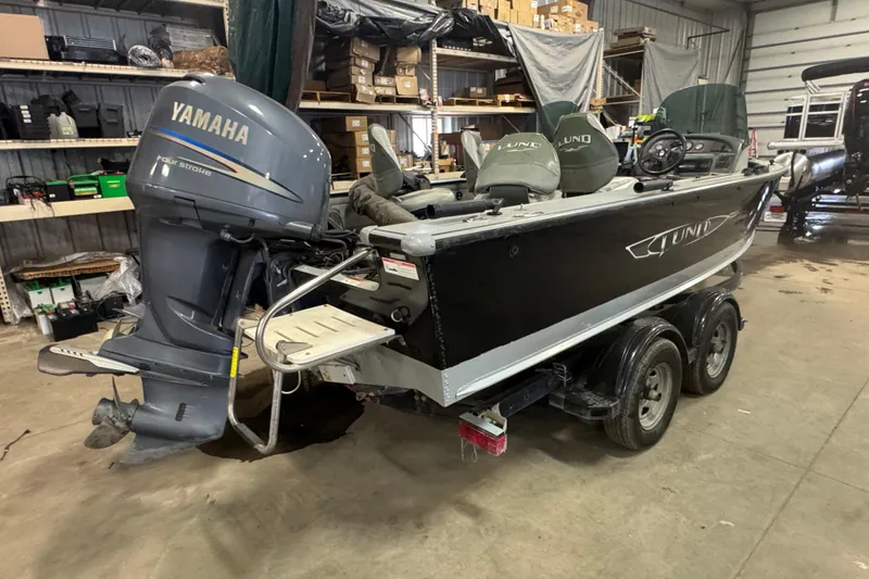 Slide: The Image of 2003 Lund 2025 Pro-V Magnum IFS boat with Yamaha outboard motor in a garage. - 3