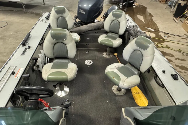 Slide: The Image of 2003 Lund 2025 Pro-V Magnum IFS boat interior with four seats and Yamaha engine. - 7