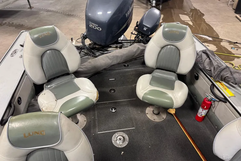 Slide: The Image of 2003 Lund 2025 Pro-V Magnum IFS boat interior with Yamaha engine and seating. - 8