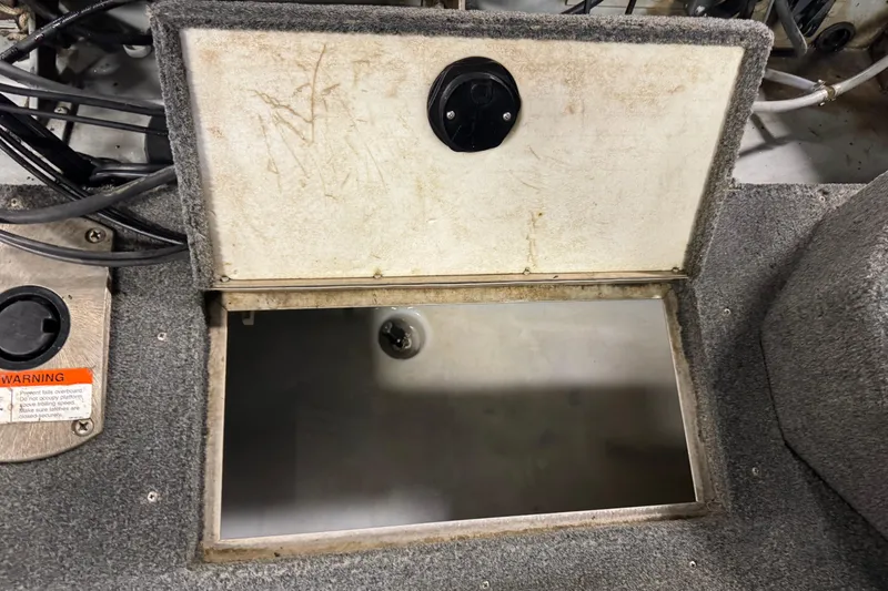 Slide: The Image of Open storage compartment in 2003 Lund 2025 Pro-V Magnum IFS boat, showing interior details. - 9