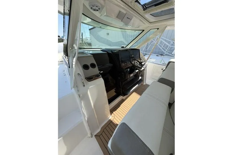 Slide: The Image of Interior view of 2022 Tiara Yachts 43 LS, featuring helm and seating area. - 10