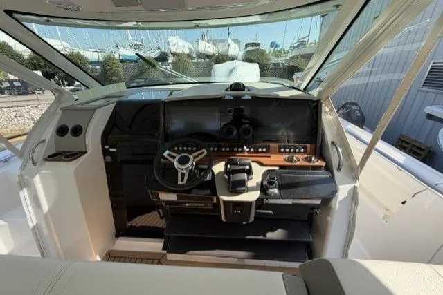 Slide: The Image of Cockpit of 2022 Tiara Yachts 43 LS, featuring modern controls and sleek design. - 11