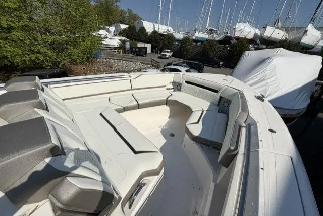 Slide: The Image of 2022 Tiara Yachts 43 LS with spacious seating area, docked among other boats. - 12