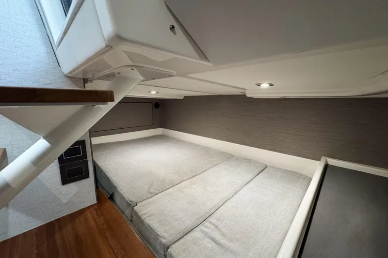 Slide: The Image of Interior cabin of 2022 Tiara Yachts 43 LS, featuring a cozy bed and modern design. - 17