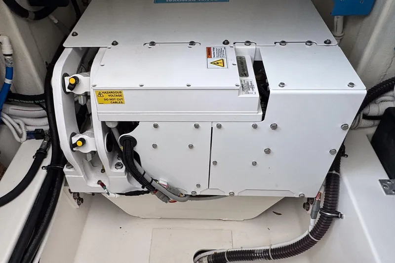 Slide: The Image of Engine compartment of 2022 Tiara Yachts 43 LS, featuring electrical components and wiring. - 19