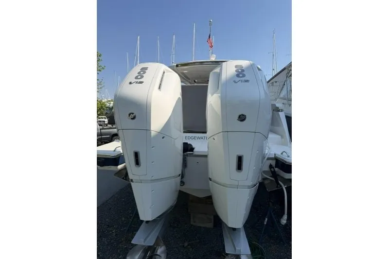 Slide: The Image of 2022 Tiara Yachts 43 LS with dual 600 V12 outboard engines, docked in a marina. - 22