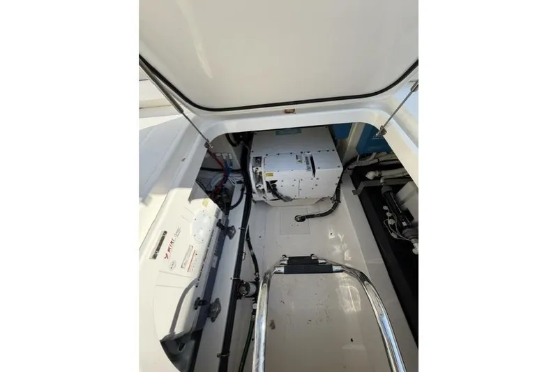 Slide: The Image of Engine compartment of 2022 Tiara Yachts 43 LS, showcasing mechanical components and wiring. - 23