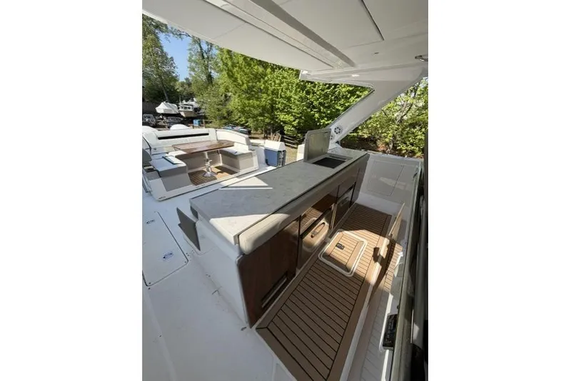 Slide: The Image of 2022 Tiara Yachts 43 LS deck with seating and outdoor kitchen area. - 8