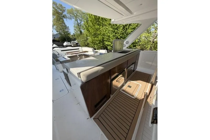 Slide: The Image of 2022 Tiara Yachts 43 LS interior with sleek kitchen and seating area. - 9