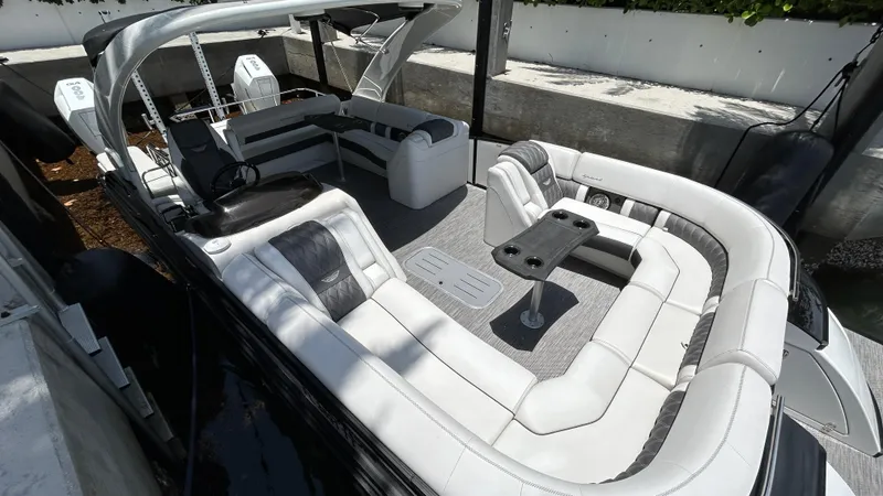 Slide: The Image of 2024 Bennington QX Line boat with luxurious seating and modern design. - 12