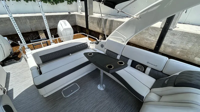 Slide: The Image of 2024 Bennington QX Line boat interior with luxurious seating and table. - 14