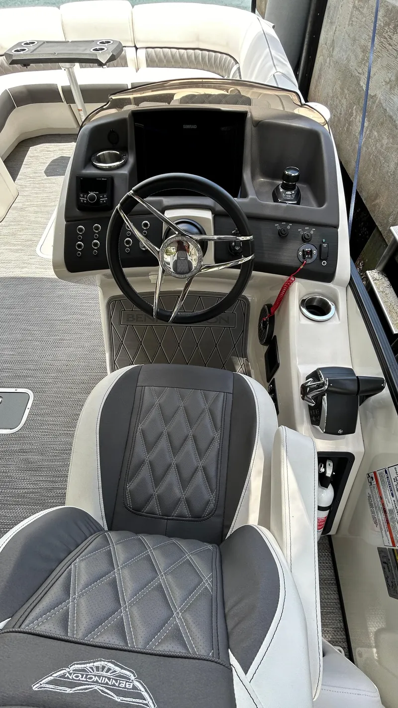 Slide: The Image of 2024 Bennington QX Line boat cockpit with steering wheel and control panel. - 16