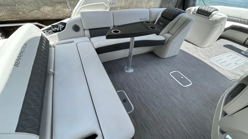 Slide: The Image of 2024 Bennington QX Line boat interior with luxurious seating and table. - 17