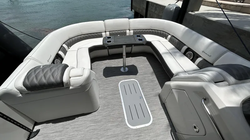 Slide: The Image of 2024 Bennington QX Line boat interior with luxurious seating and table. - 19