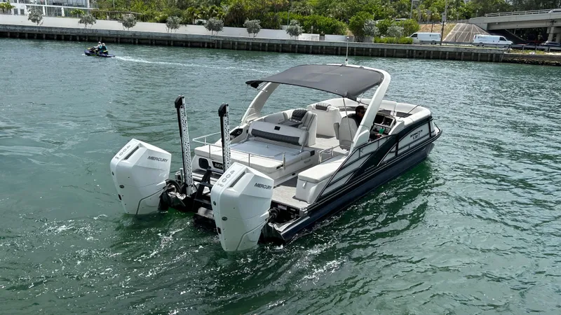 Slide: The Image of 2024 Bennington QX Line boat with dual Mercury outboard engines on the water. - 6