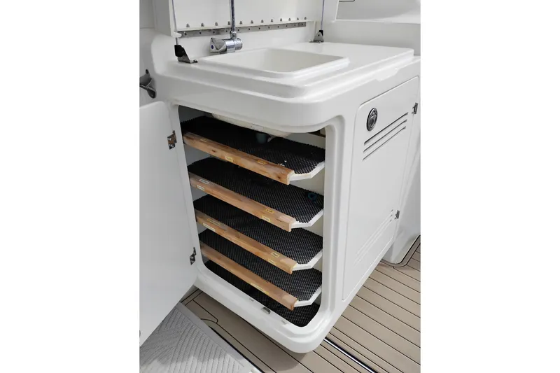 Slide: The Image of 2005 Silverton 38 Convertible boat interior with open cabinet and sink. - 17