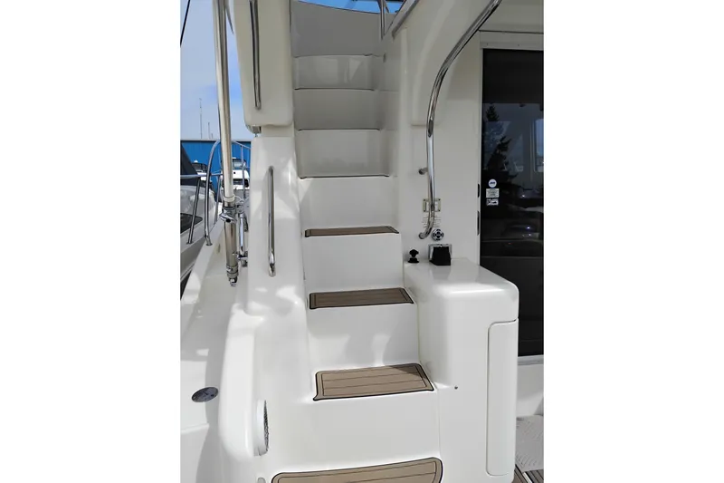 Slide: The Image of Staircase on 2005 Silverton 38 Convertible yacht, featuring sleek design and stainless steel railings. - 20