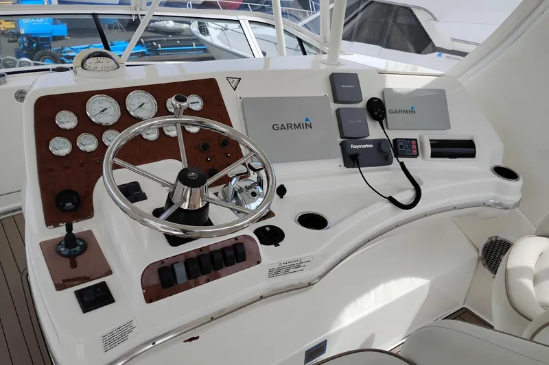 Slide: The Image of Helm of 2005 Silverton 38 Convertible with Garmin navigation and Raymarine equipment. - 21