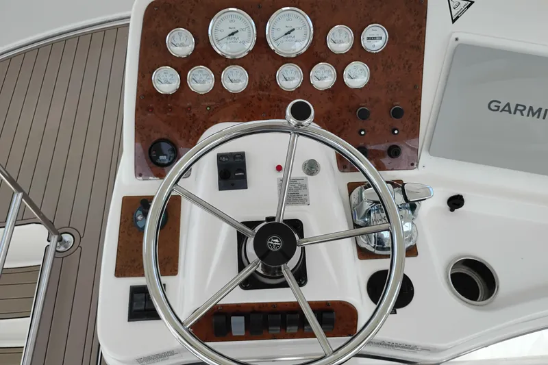 Slide: The Image of 2005 Silverton 38 Convertible yacht helm with gauges and Garmin navigation system. - 23