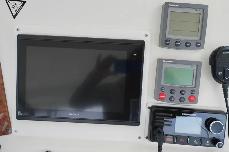Slide: The Image of Control panel of a 2005 Silverton 38 Convertible with Garmin and Raymarine electronics. - 27