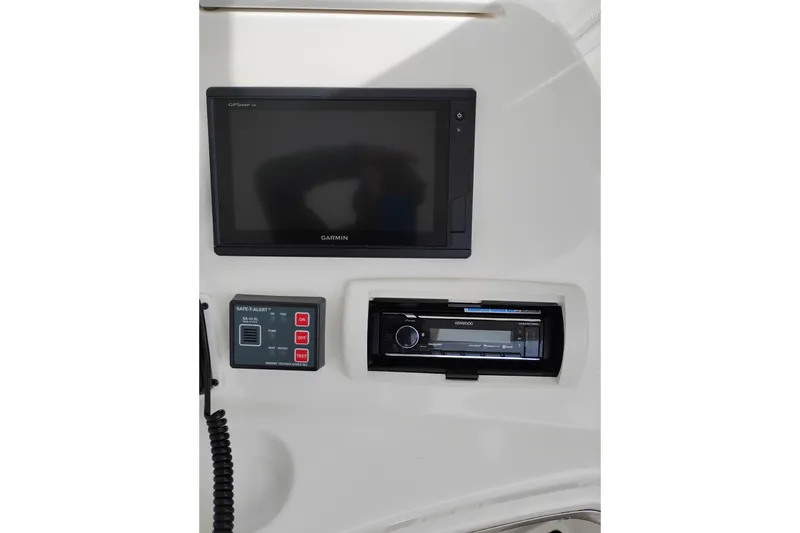 Slide: The Image of 2005 Silverton 38 Convertible dashboard with Garmin GPS and Kenwood stereo system. - 28